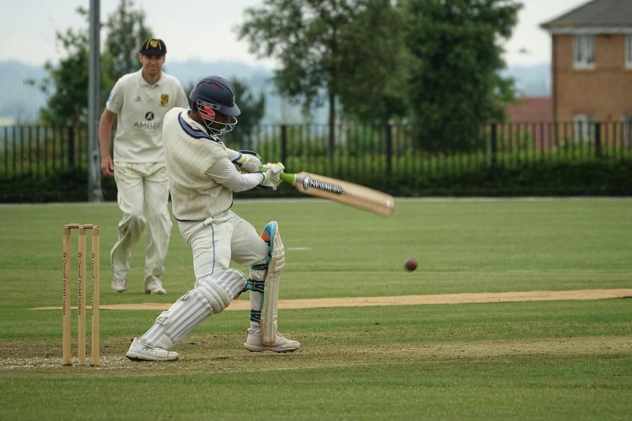 cricket player swinging a bat